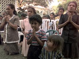 People pray at Belo's church after attack by militias